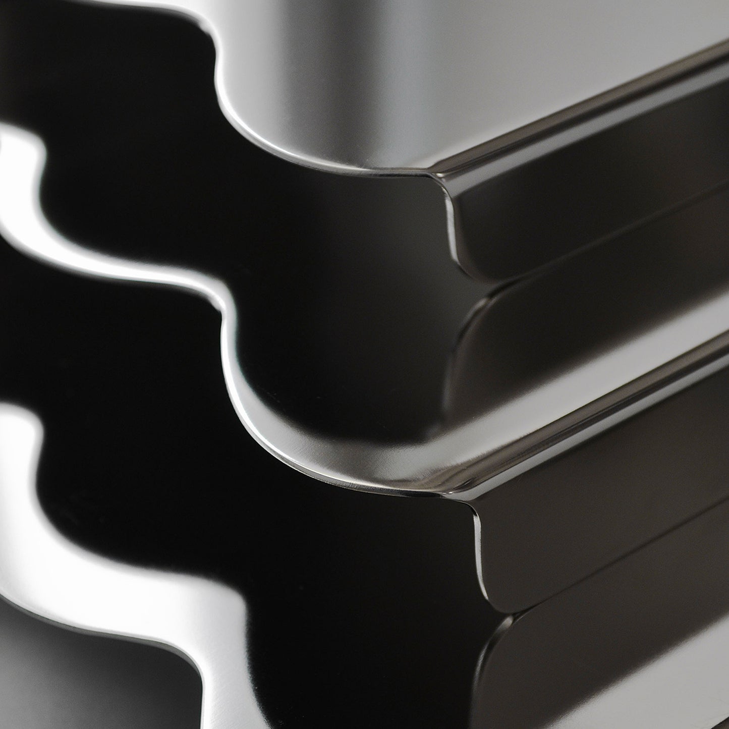 Close-up of the wavy edges of the stainless steel modern serving stands