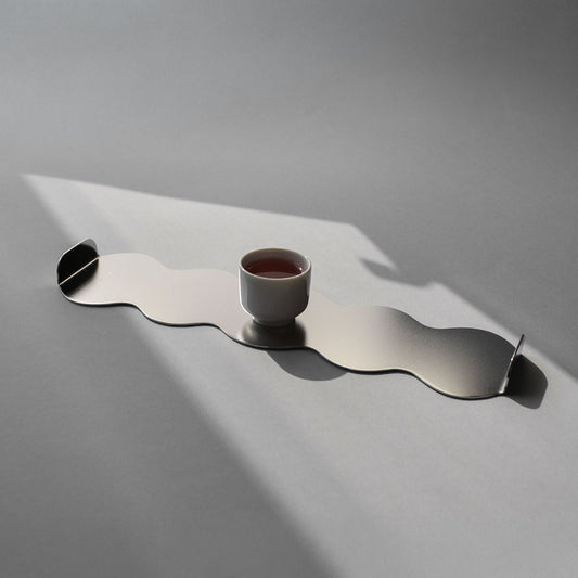 Wavy stainless steel tray with a soft matt finish and a small cup