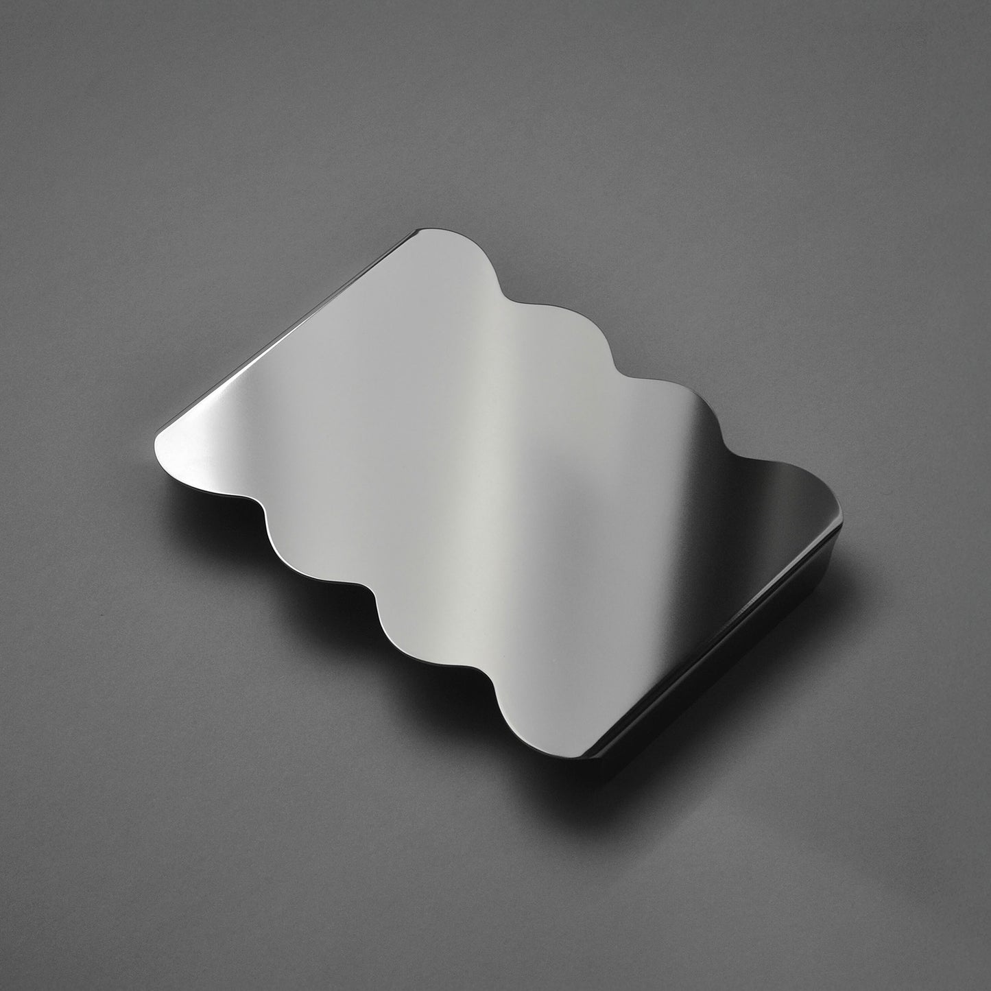 Stainless steel sculptural serving stand in mirror finish