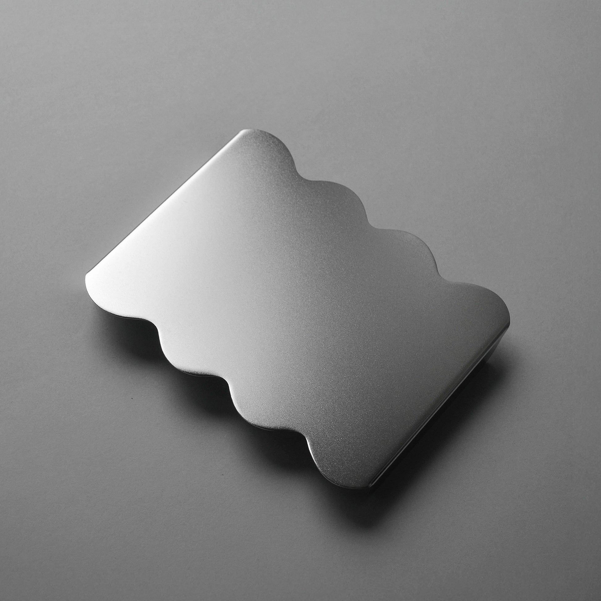 Wavy shaped stainless steel serving stand with soft surface