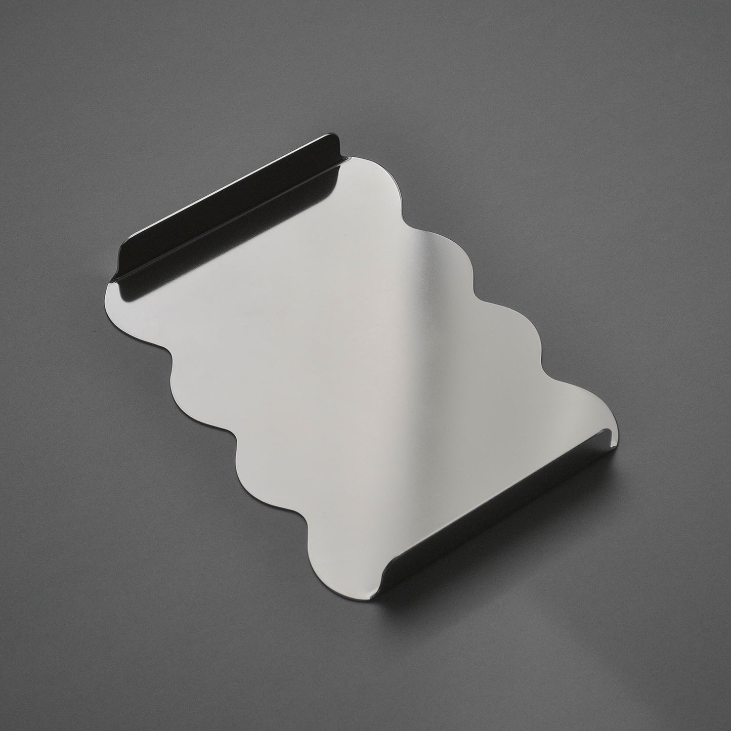 Top view of the stainless steel sculptural tray with curvy edges