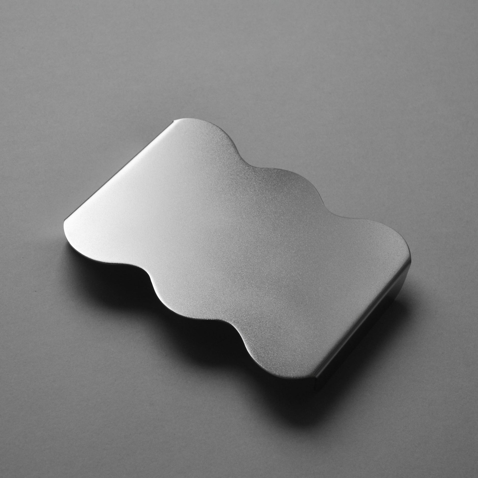 Top view of the contemporary seving tray wuith wavy edges in satin finish