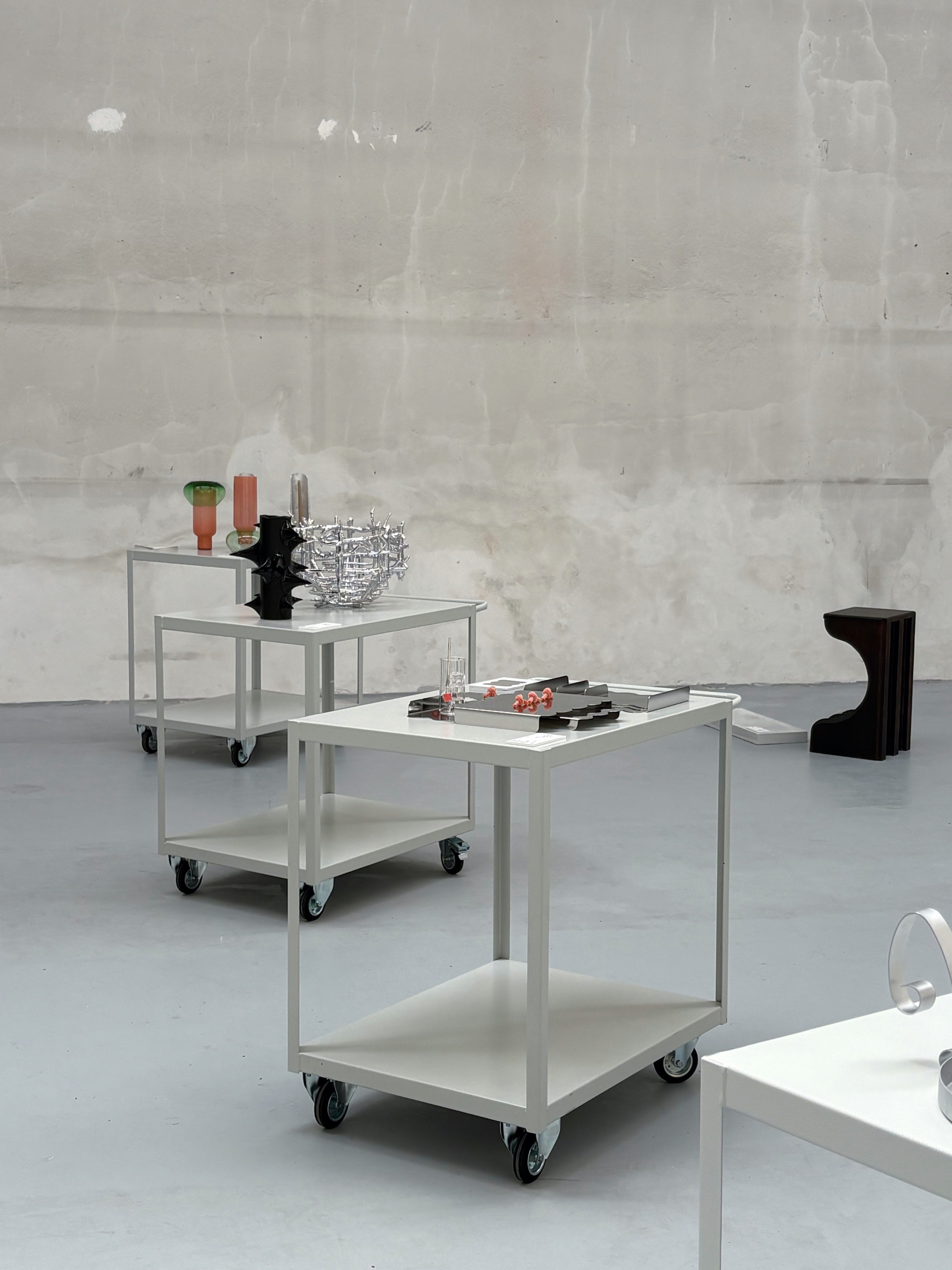 Metal trays on serving wheel in an industrial building on milan design week
