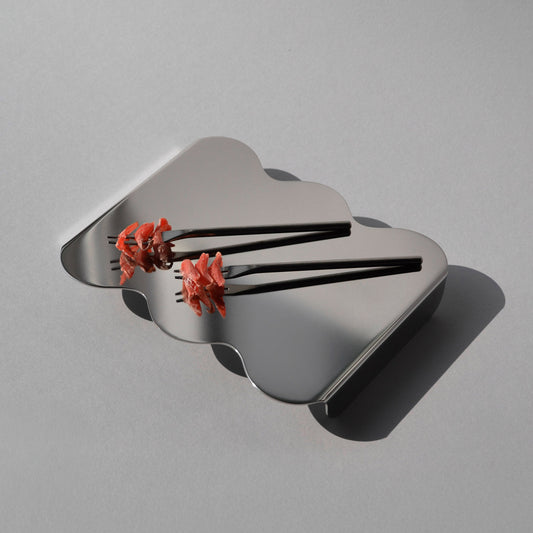 Top view of the sculptural serving stand in stainless steel with red edible petals on top